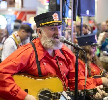 Casey and The Atta Boys performing from Silver Dollar City and Rocky Mountain Construction booth at IAAPA Expo 2023